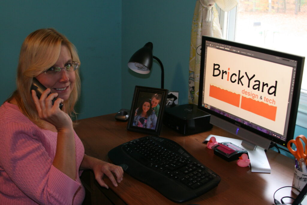 Wendy on the phone while working at the computer